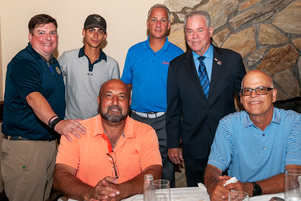 County Executive Ed Day with HHHF board member Brendan Martin (l, standing) and other golfers at dinner